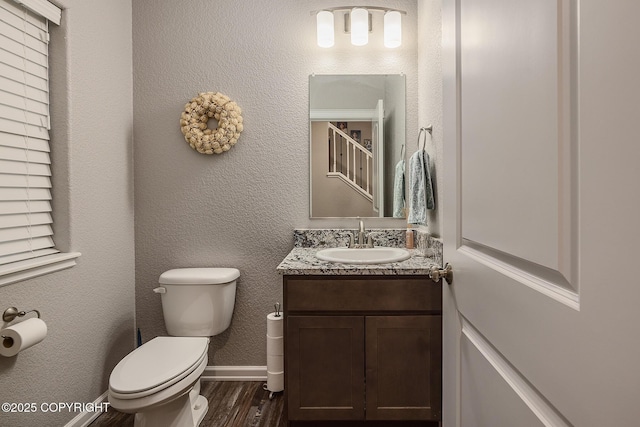 bathroom with vanity, hardwood / wood-style floors, and toilet