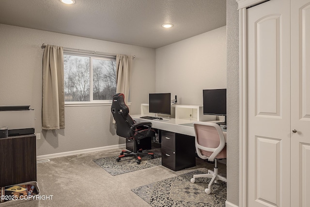 office featuring carpet floors and a textured ceiling