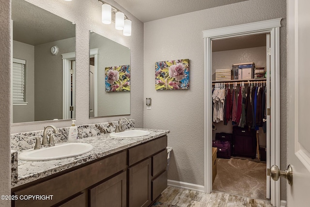 bathroom with vanity and a textured ceiling