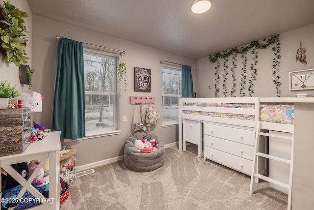 carpeted bedroom featuring a textured ceiling