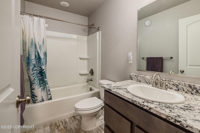 full bathroom with toilet, shower / tub combo, a textured ceiling, vanity, and hardwood / wood-style flooring