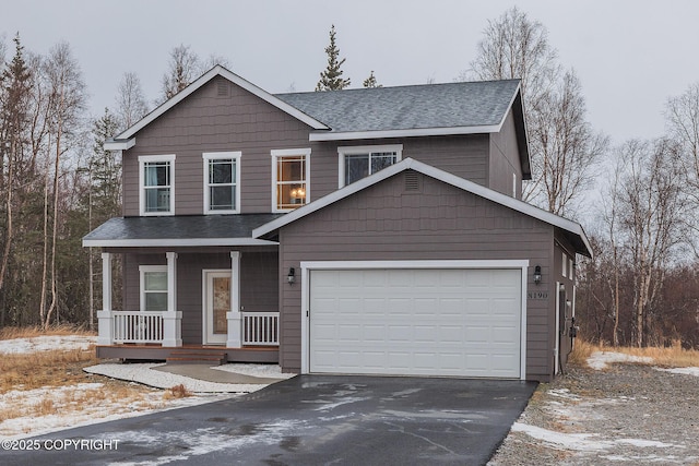 view of front of property featuring a garage and a porch