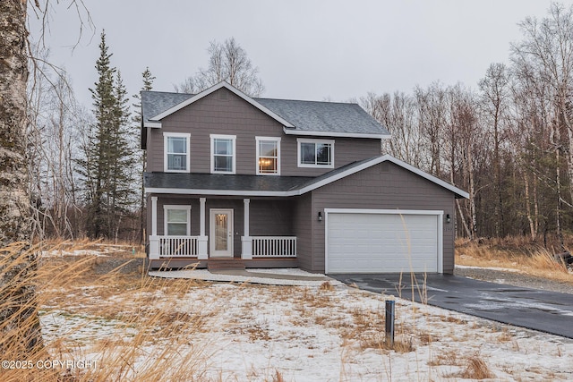 view of front property with a porch and a garage