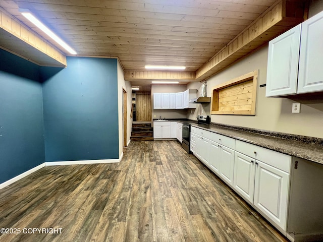 kitchen featuring dark hardwood / wood-style flooring, white cabinetry, wooden ceiling, wall chimney range hood, and stainless steel electric range