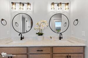 full bathroom featuring double vanity and a sink