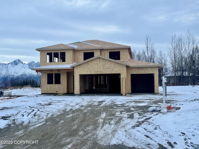 view of front of home with a garage, a mountain view, and roof with shingles