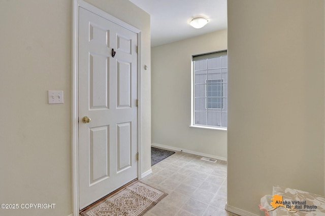 hall with visible vents and baseboards