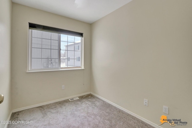 empty room featuring visible vents, baseboards, and carpet floors