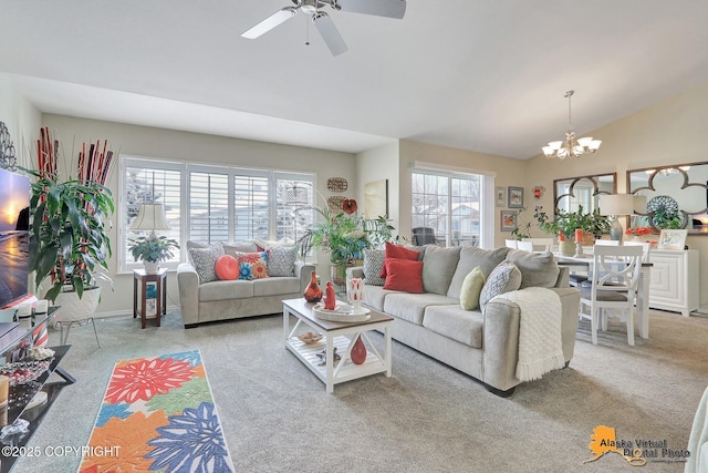 living room featuring lofted ceiling, carpet flooring, ceiling fan with notable chandelier, and a wealth of natural light