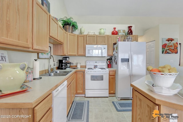 kitchen with a sink, white appliances, light brown cabinetry, and light countertops