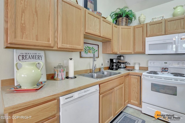 kitchen featuring a sink, white appliances, light brown cabinets, and light countertops