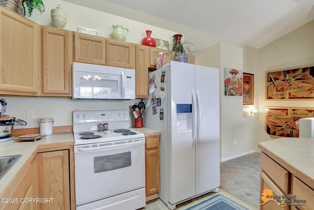 kitchen featuring light brown cabinetry, light countertops, vaulted ceiling, light carpet, and white appliances