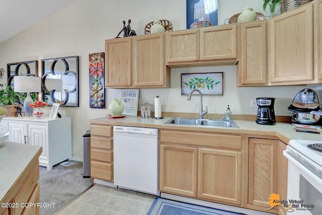 kitchen featuring light brown cabinets, a sink, white appliances, light countertops, and vaulted ceiling