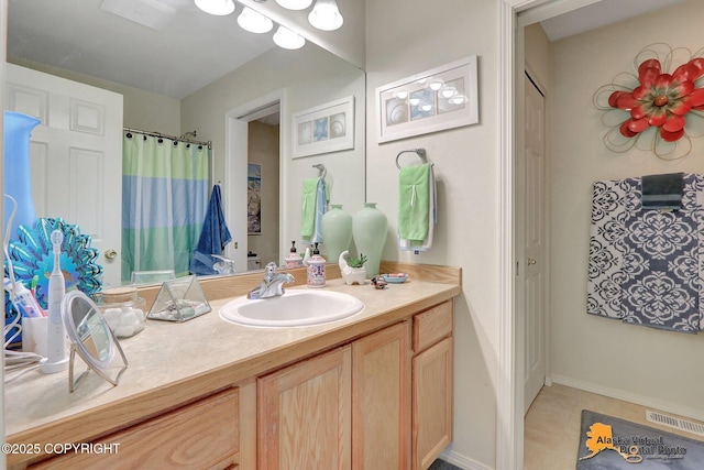 bathroom with vanity, a shower with curtain, visible vents, and tile patterned flooring