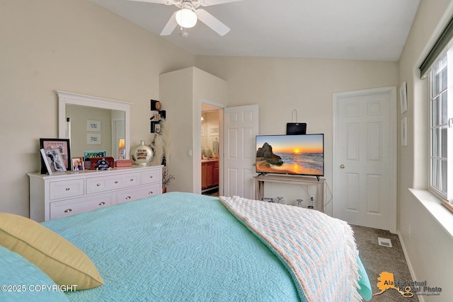 carpeted bedroom featuring visible vents, a ceiling fan, and vaulted ceiling