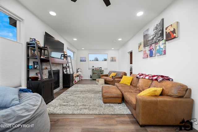 living room featuring wood-type flooring and ceiling fan