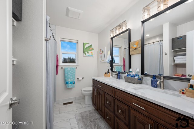 bathroom featuring vanity and toilet