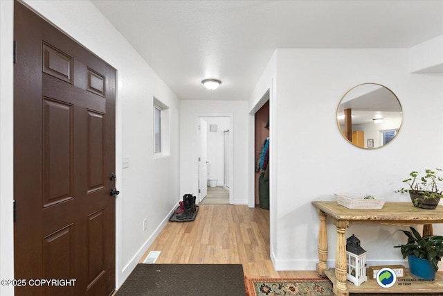 foyer with light wood-type flooring