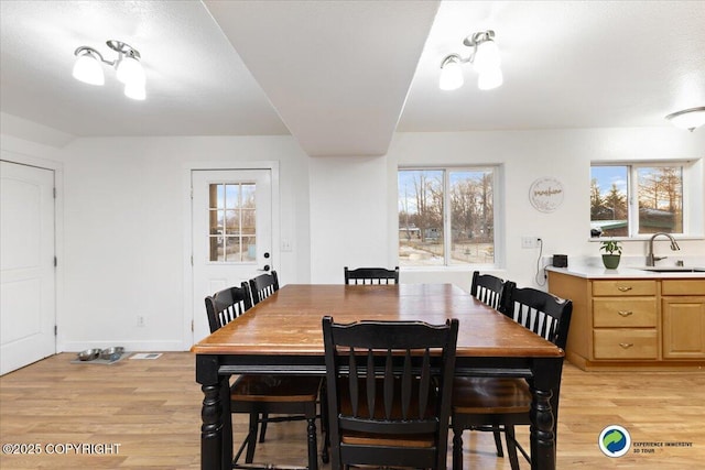 dining room with sink and light hardwood / wood-style floors