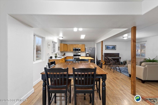 dining room featuring sink and light hardwood / wood-style flooring