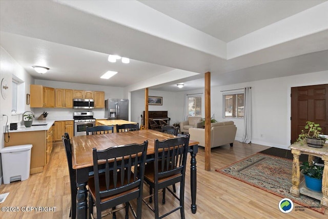 dining room with sink and light hardwood / wood-style floors