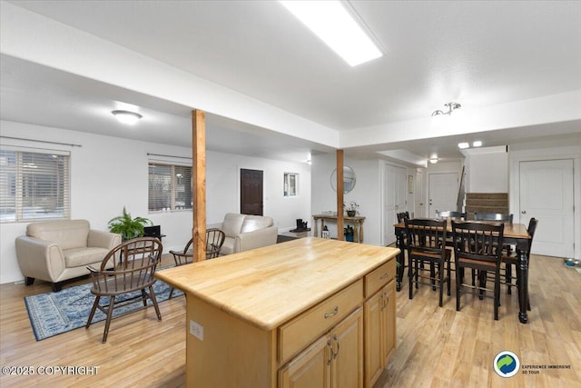 kitchen with a center island, light brown cabinets, and light hardwood / wood-style floors