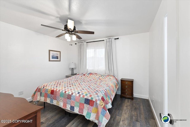 bedroom with dark hardwood / wood-style flooring and ceiling fan