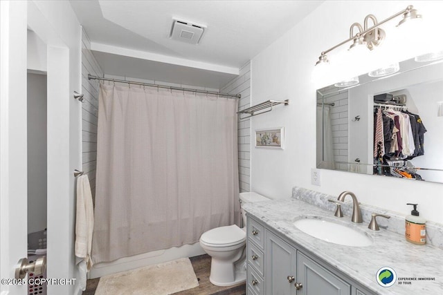 full bathroom featuring vanity, toilet, shower / tub combo, and wood-type flooring