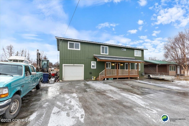 view of front of home with a garage and a porch