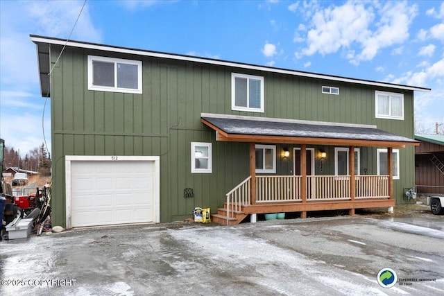 front facade featuring a garage and covered porch