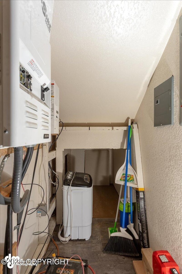 utility room featuring electric panel and water heater