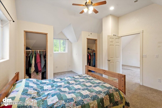 bedroom with a walk in closet, light carpet, and lofted ceiling