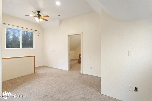 empty room with light carpet, ceiling fan, and lofted ceiling