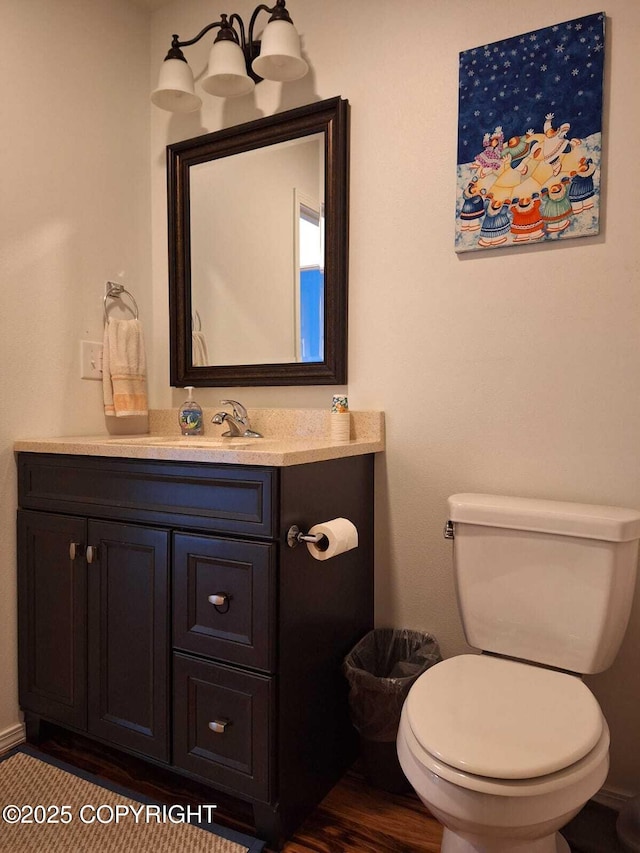 bathroom featuring vanity and toilet