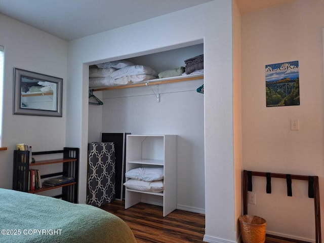 bedroom with dark hardwood / wood-style flooring