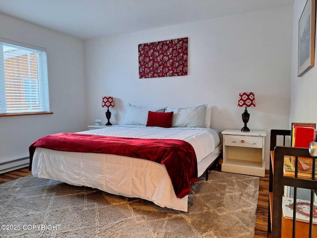 bedroom with wood-type flooring and baseboard heating