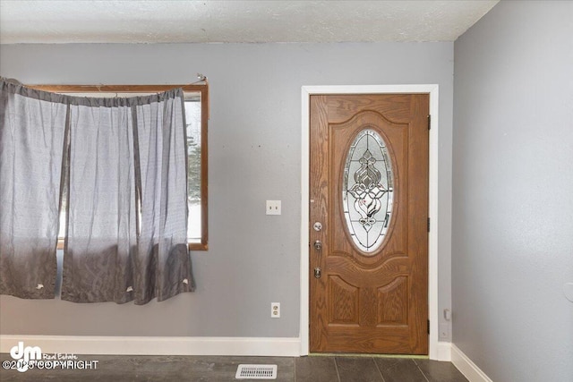 foyer with a textured ceiling