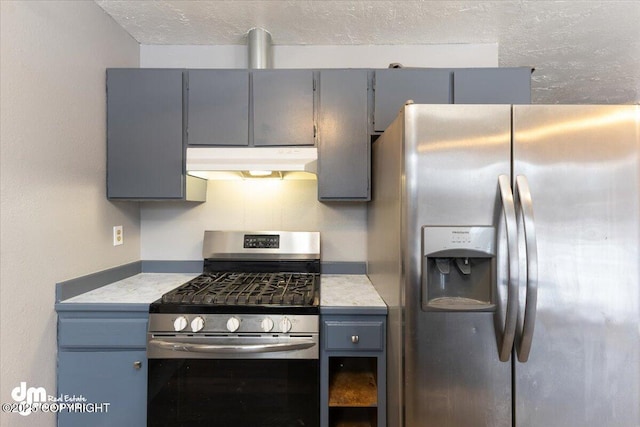 kitchen featuring stainless steel appliances and gray cabinetry