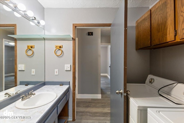 bathroom with vanity, washer and clothes dryer, and wood-type flooring