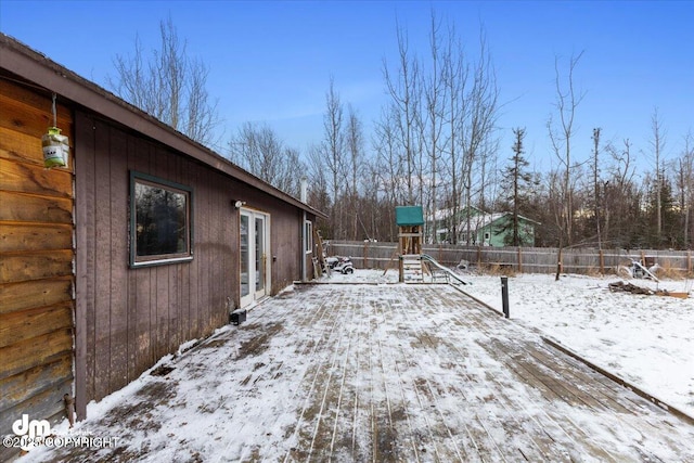 snowy yard featuring a playground