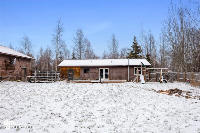 snow covered property featuring french doors