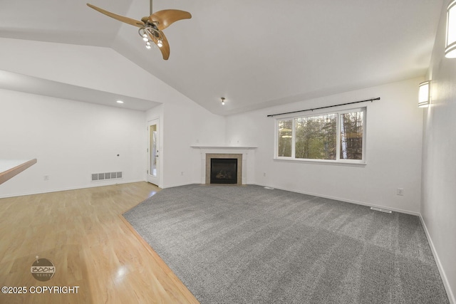 unfurnished living room featuring vaulted ceiling, ceiling fan, and hardwood / wood-style floors