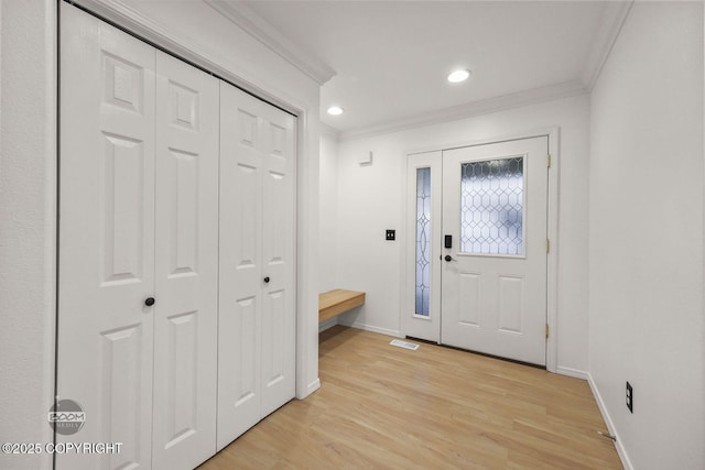 entryway featuring light hardwood / wood-style flooring and ornamental molding