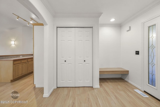 entrance foyer with light wood-type flooring and crown molding