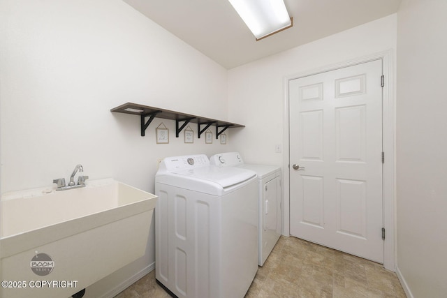 clothes washing area featuring sink and independent washer and dryer