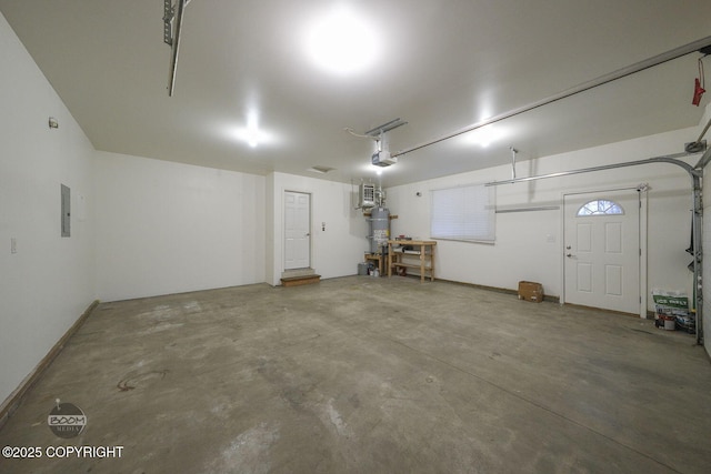 garage with a garage door opener and secured water heater