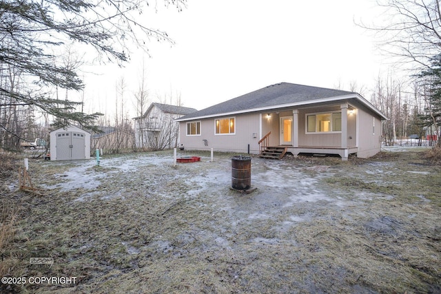 back of house featuring a shed