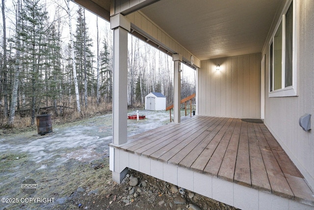 wooden terrace with a storage shed