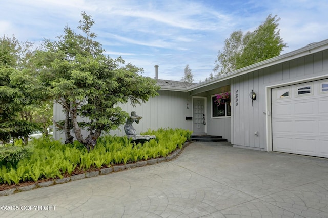 4800 Folker St, Anchorage, AK 99507 - doorway to property featuring an attached garage