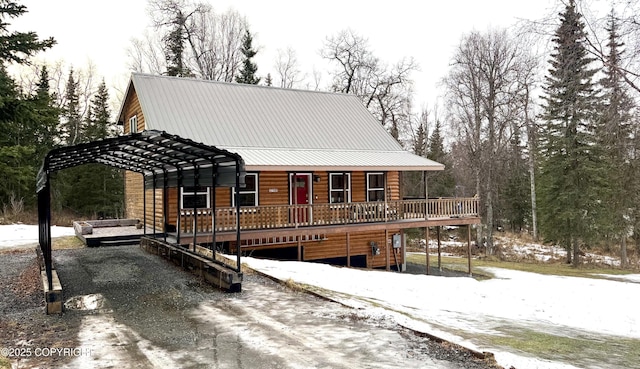 cabin with a carport and a deck